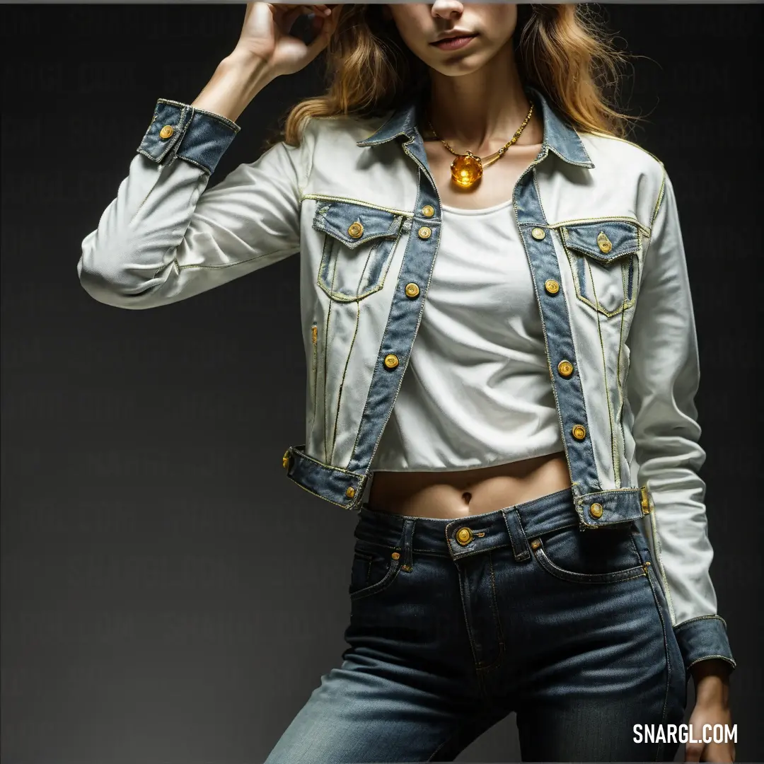 Woman in a white shirt and jean jacket with a gold necklace and a necklace on her neck