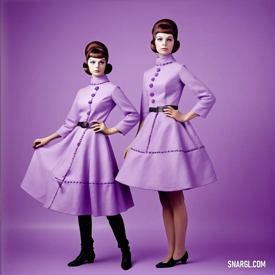 Two women in purple dresses standing next to each other on a purple background with a black belt