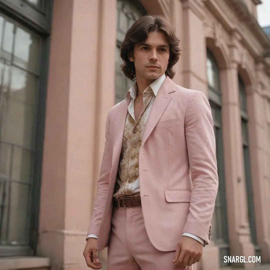 Man in a pink suit standing in front of a building with a tie on his neck