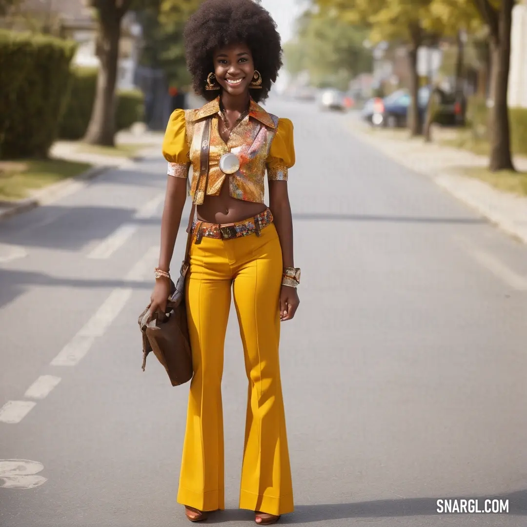 Woman in yellow pants and a yellow top is standing on the street with a purse