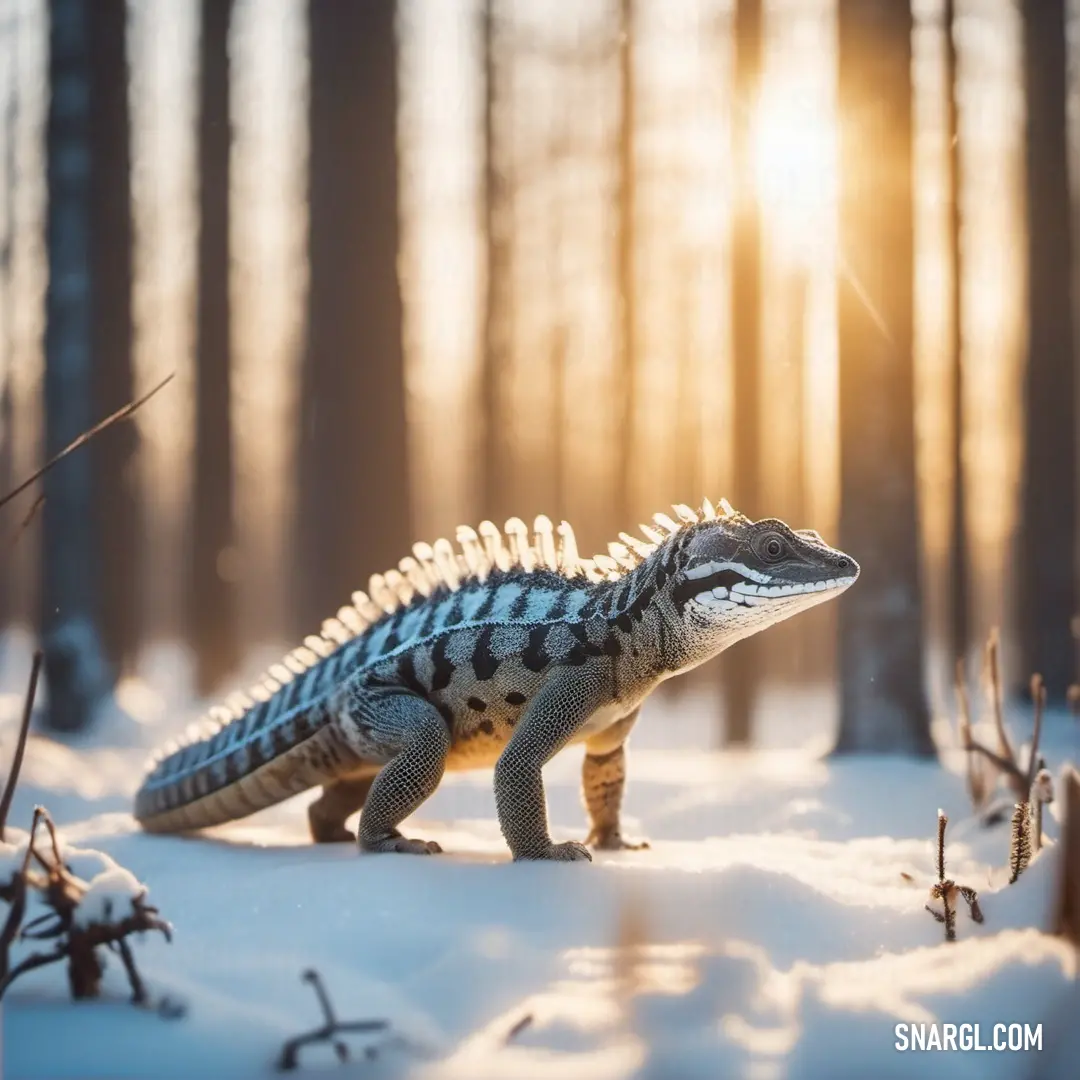 Small lizard is standing in the snow in the woods with the sun shining through the trees behind it