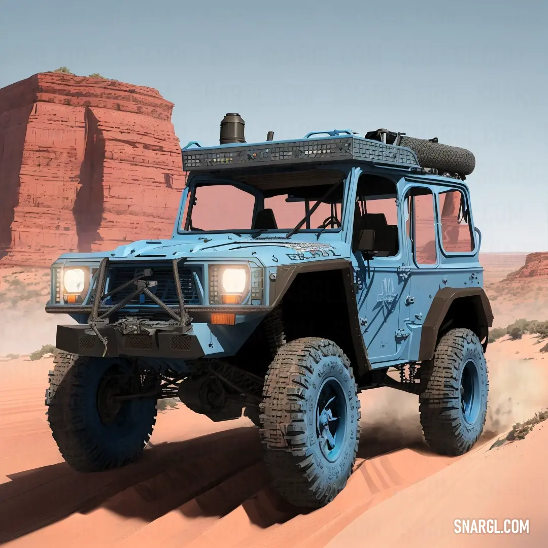 Blue truck driving through a desert area with a rock formation in the background