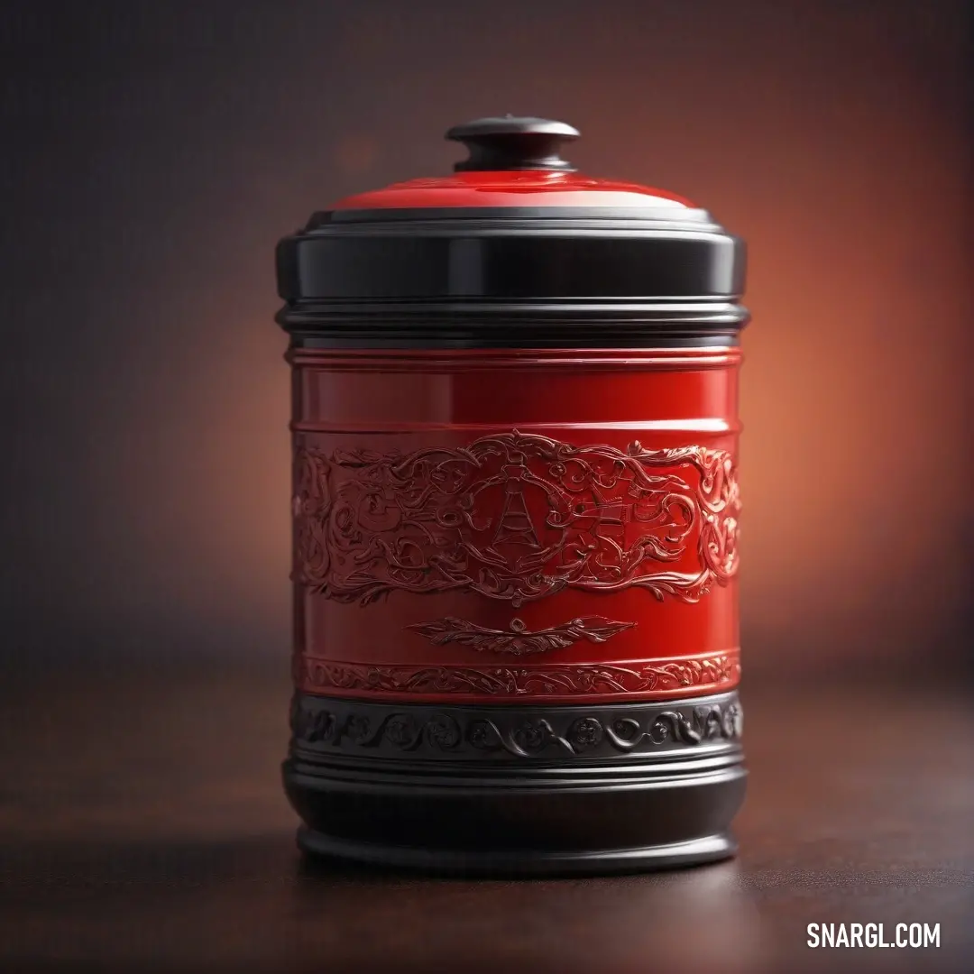 A red jar with a black lid rests on a table, set against a dark, moody background. The rich alizarin crimson of the jar contrasts beautifully with the deep shadows, highlighting its shape and the subtle gloss of its surface.