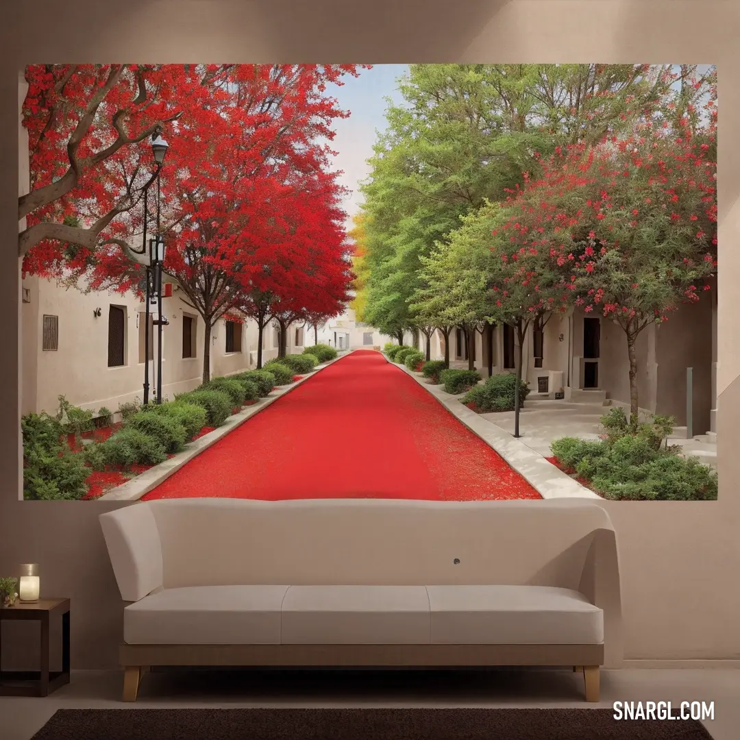 Living room with a couch and a painting on the wall of a red road that is lined with trees