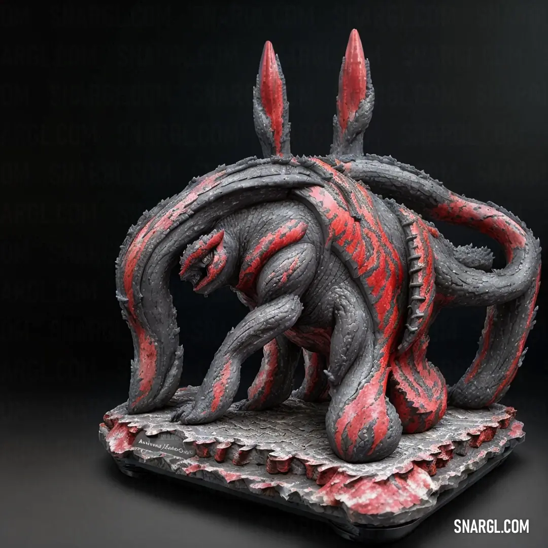 Sculpture of a red and black creature on a black background