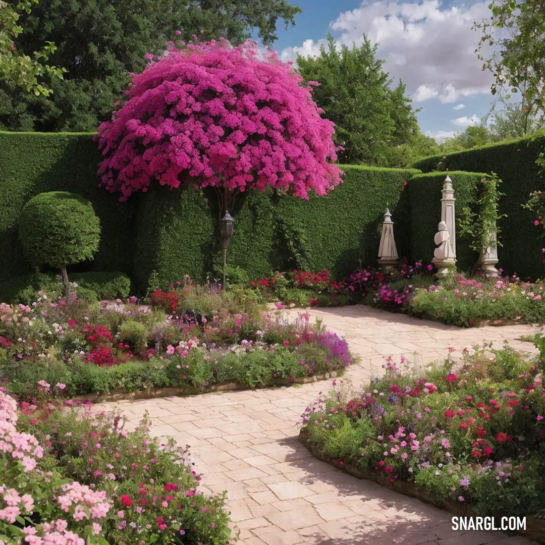 Garden with a path and a large tree in the middle of it with flowers all around it