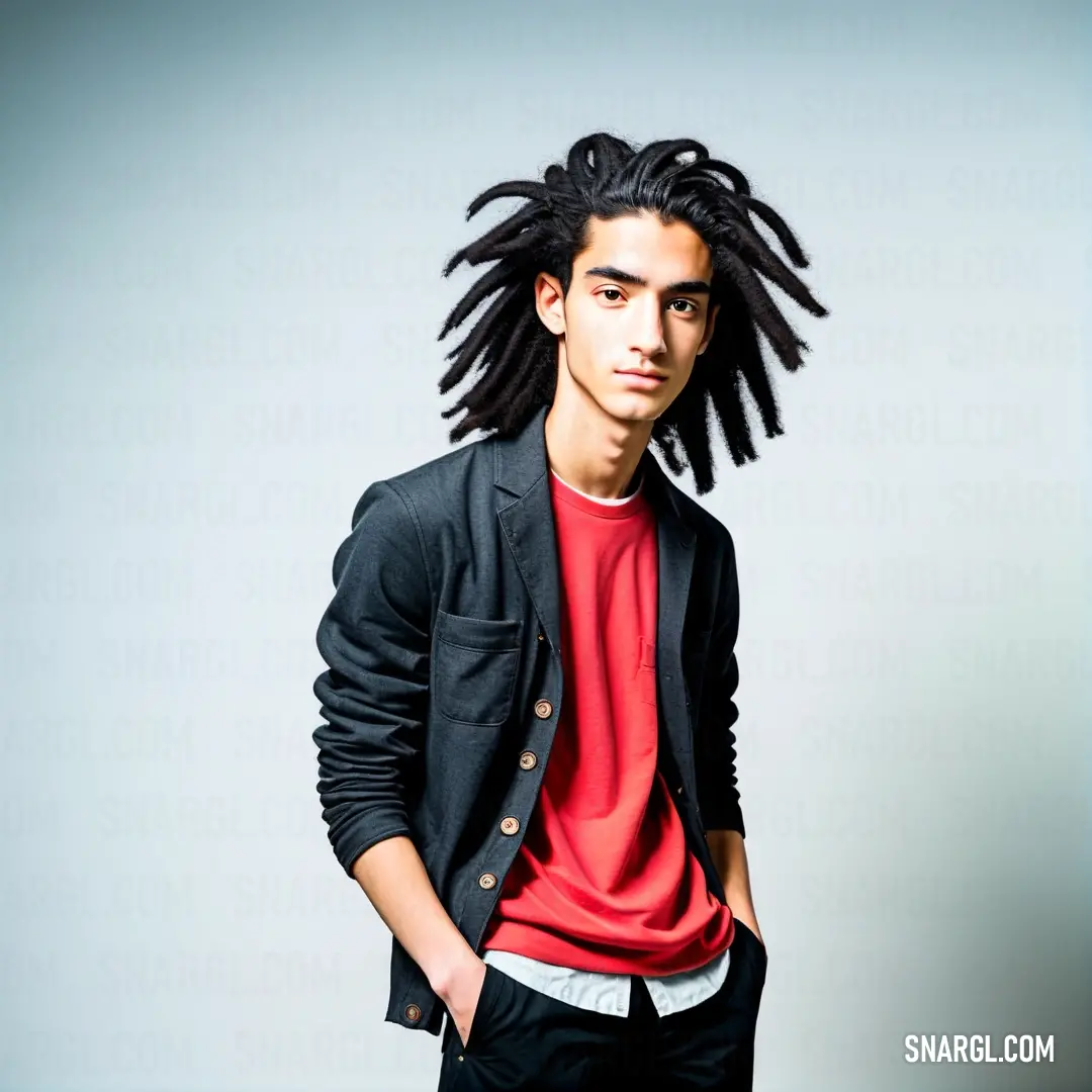 American rose color. Man with dreadlocks standing in front of a white background wearing a red shirt and black jacket