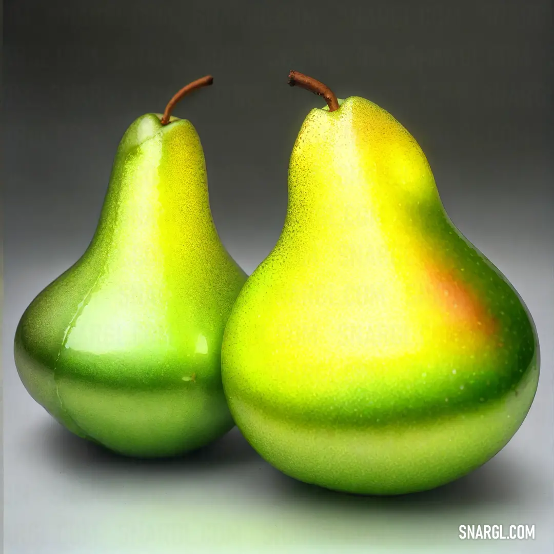 Two pears are side by side on a gray background with a green center and a brown stem