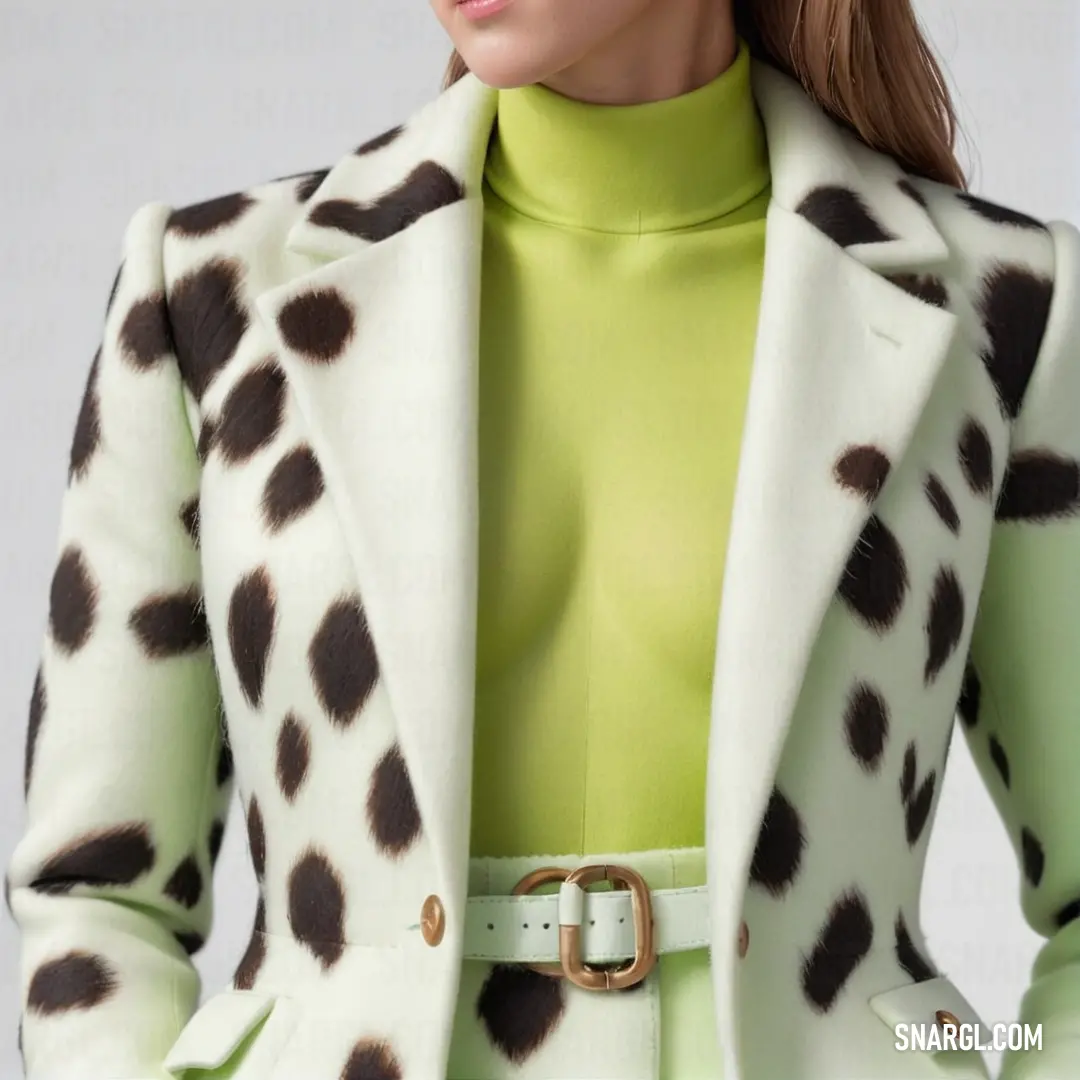 Woman in a green shirt and a white jacket with black spots on it and a belt around her waist