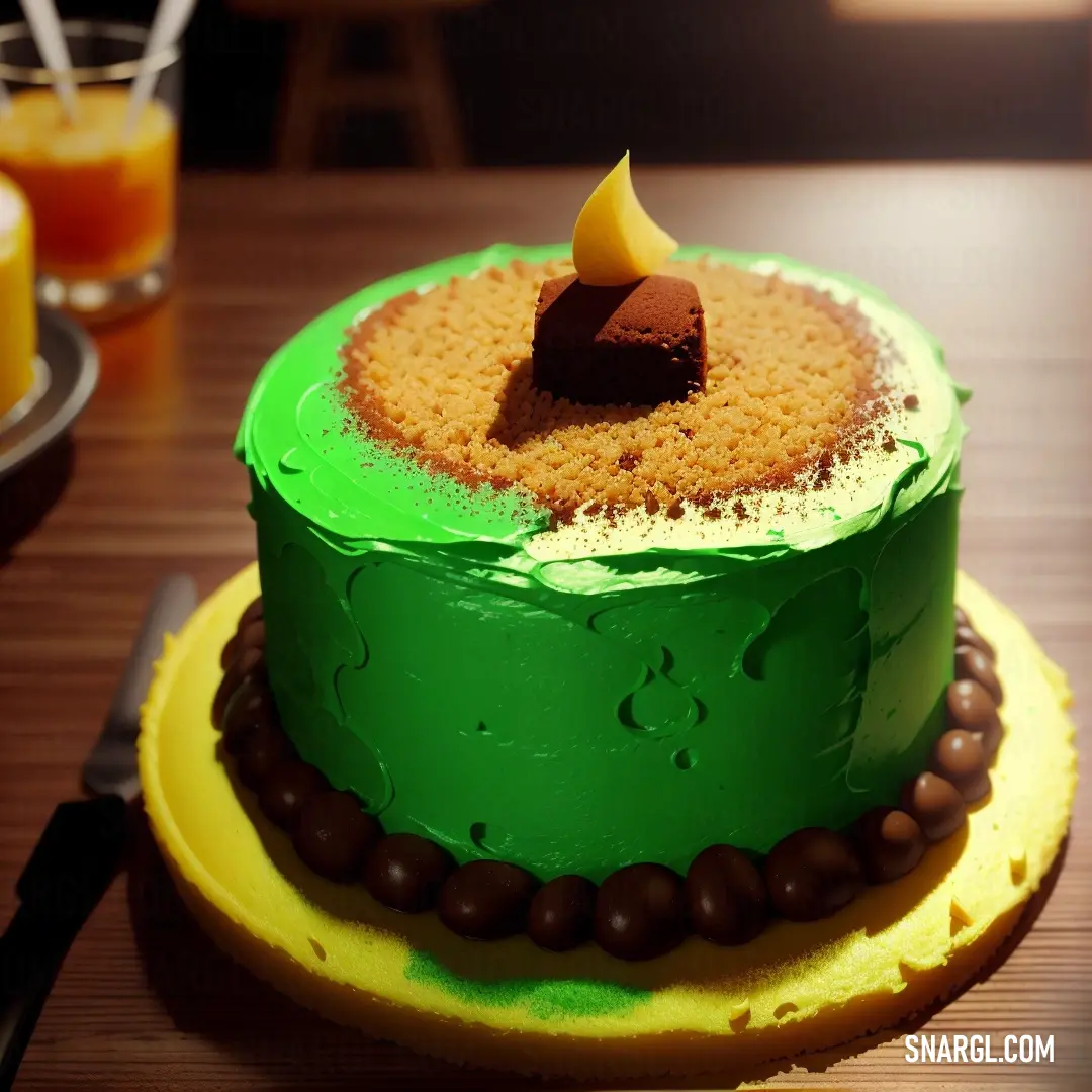 Green cake with a slice of chocolate on top of it on a yellow plate with a fork and a glass of orange juice