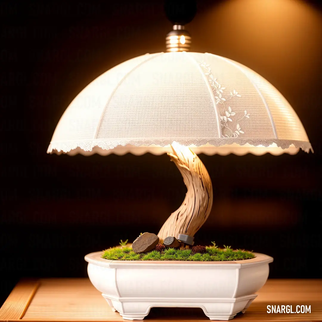 An elegant lamp with a decorative plant at its base, radiating a warm glow from its lamp shade, casting a soft light that adds a cozy touch to any room.