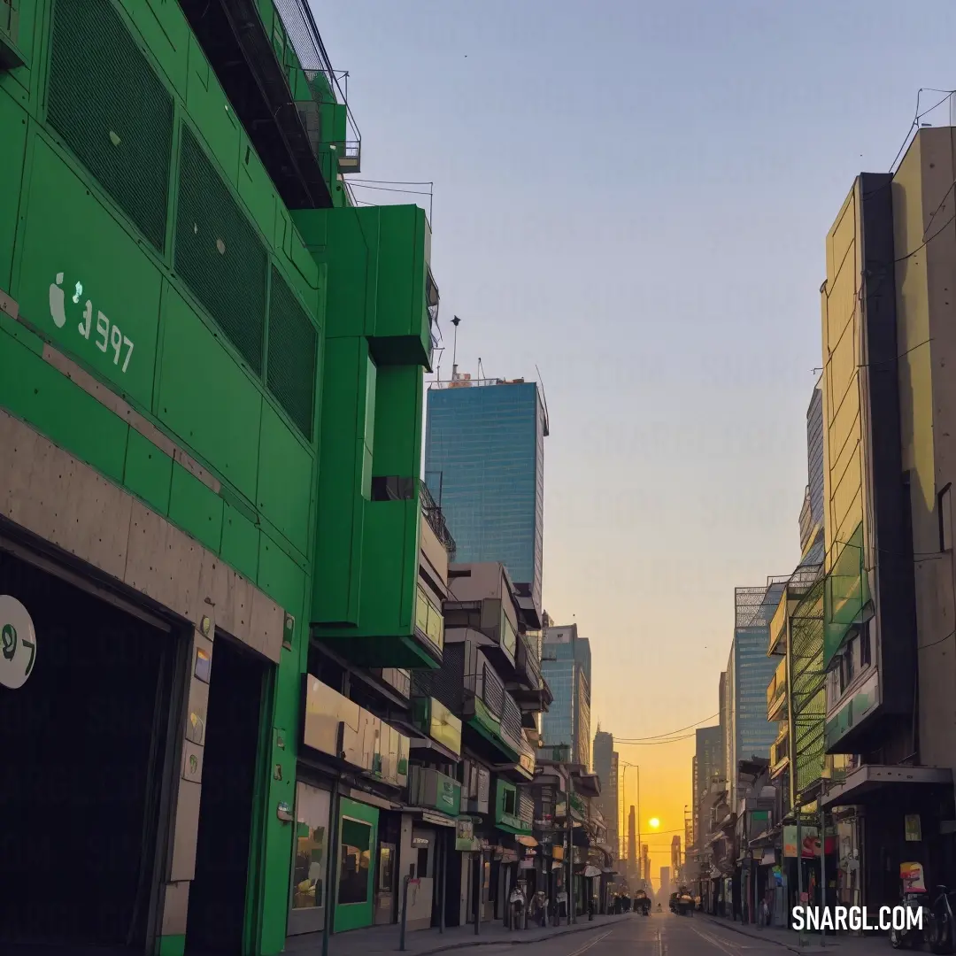 Street with buildings and a car on it at sunset or dawn in a city with tall buildings and a few cars parked on the street