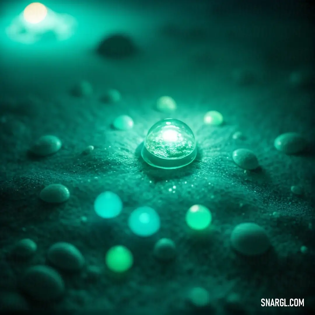 Green light shines on a surface with small bubbles of water on it. Example of Aquamarine color.