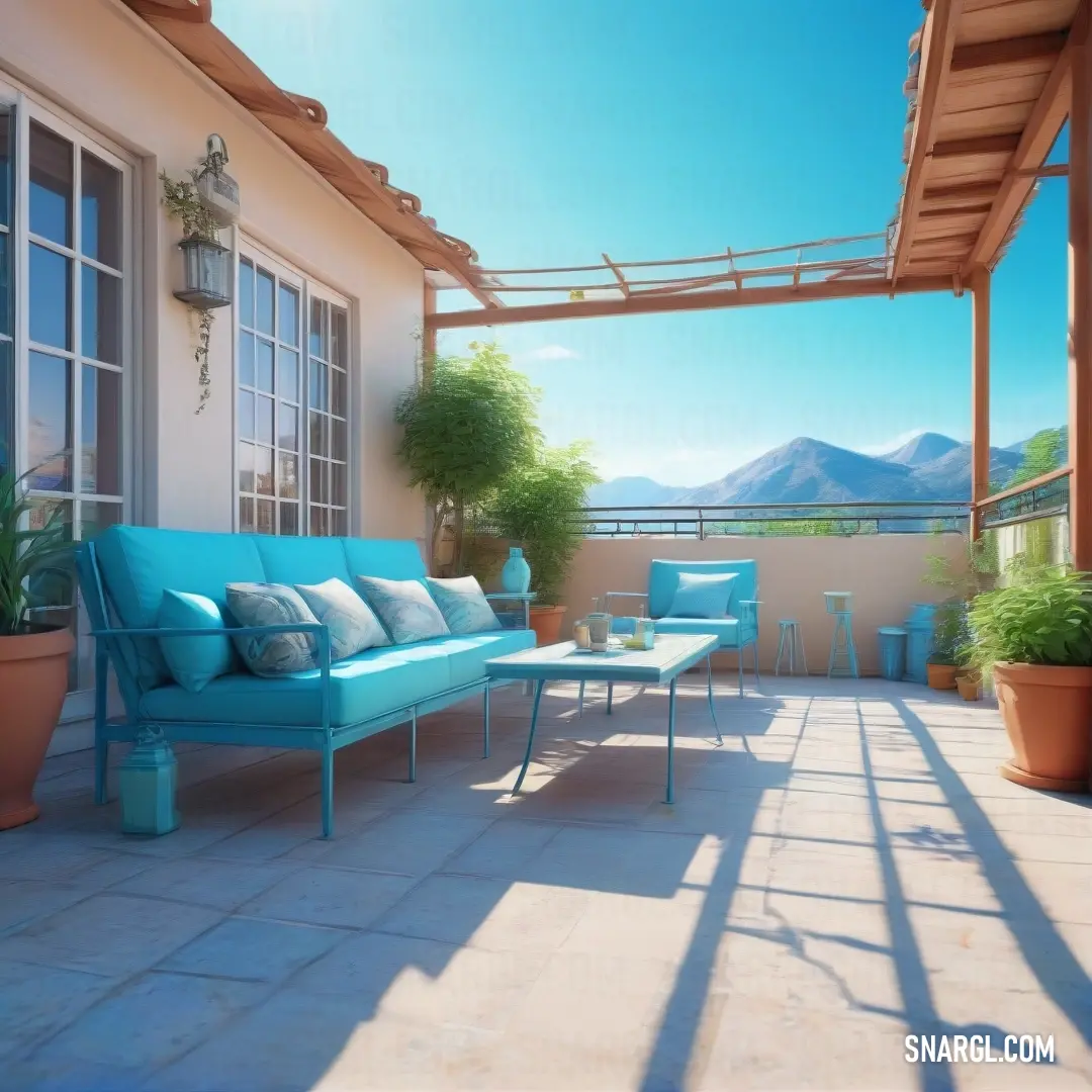 Blue couch on top of a patio next to a table and chairs with a mountain view in the background. Color Baby blue.