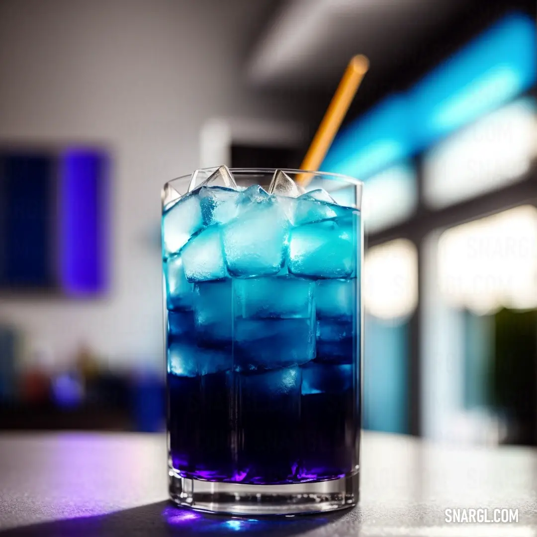 Blue drink with ice in a glass on a table with a straw in it and a blue light behind it