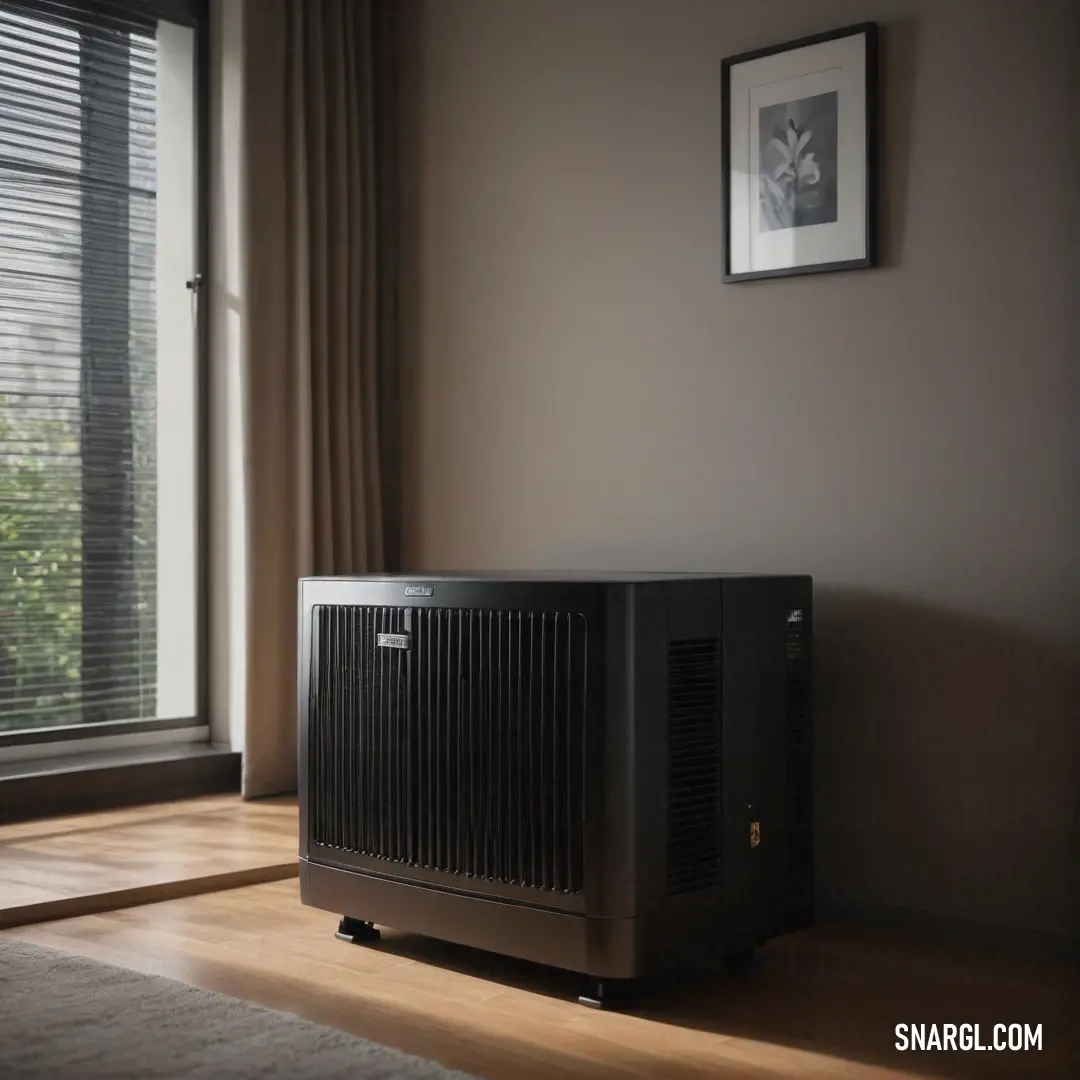 A compact air conditioner is thoughtfully placed on a polished hardwood floor beneath a window adorned with outer blinds. It offers a glimpse of functionality meeting aesthetics, essential for comfort in warm weather while blending seamlessly into the roo