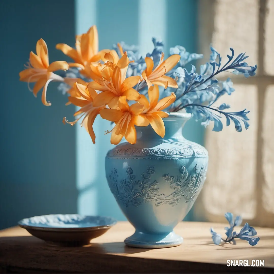 Blizzard Blue color. Blue vase with yellow flowers in it on a table next to a plate and window sill with blue curtains