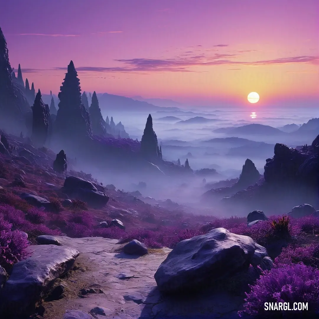 Purple and pink sunset over a mountain range with rocks and plants on the ground and a trail leading to the horizon