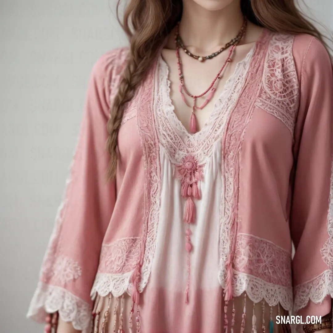 Woman wearing a pink top with a lace trim around the neck