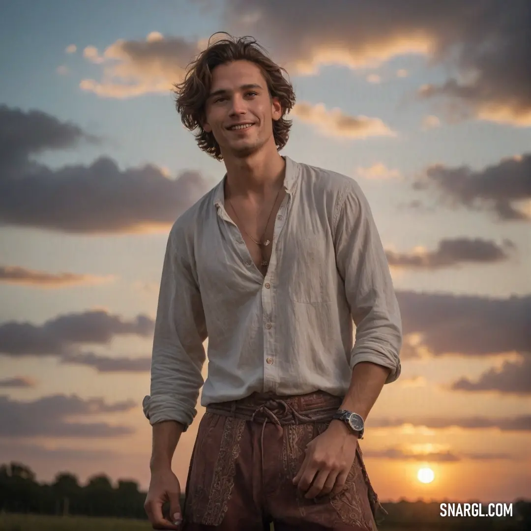 Man standing in a field with the sun setting behind him