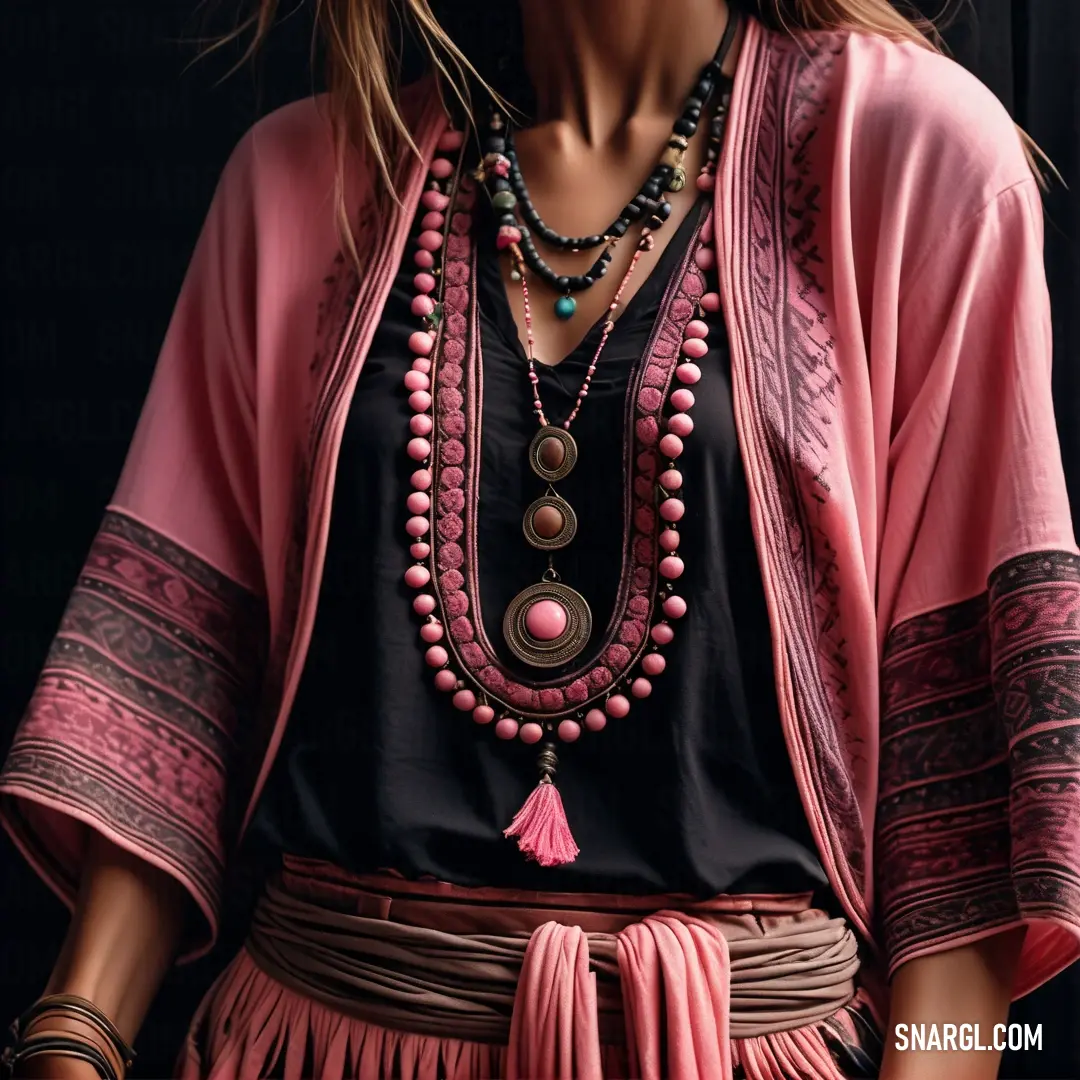 Woman wearing a pink and black outfit and a necklace with beads