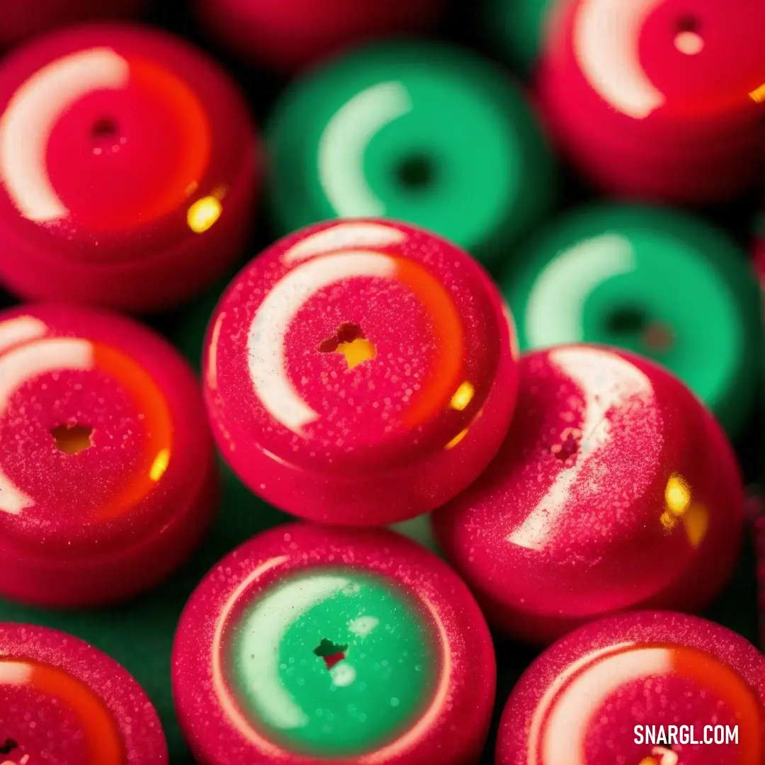 Close up of a bunch of red and green buttons with holes in them