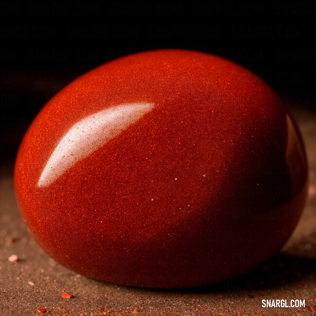 Red egg on top of a table next to a cup of coffee and a spoon with a liquid inside