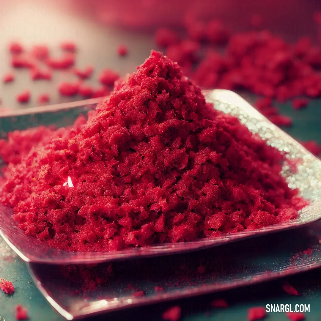 Spoon full of red powder on a table with scattered red petals on it