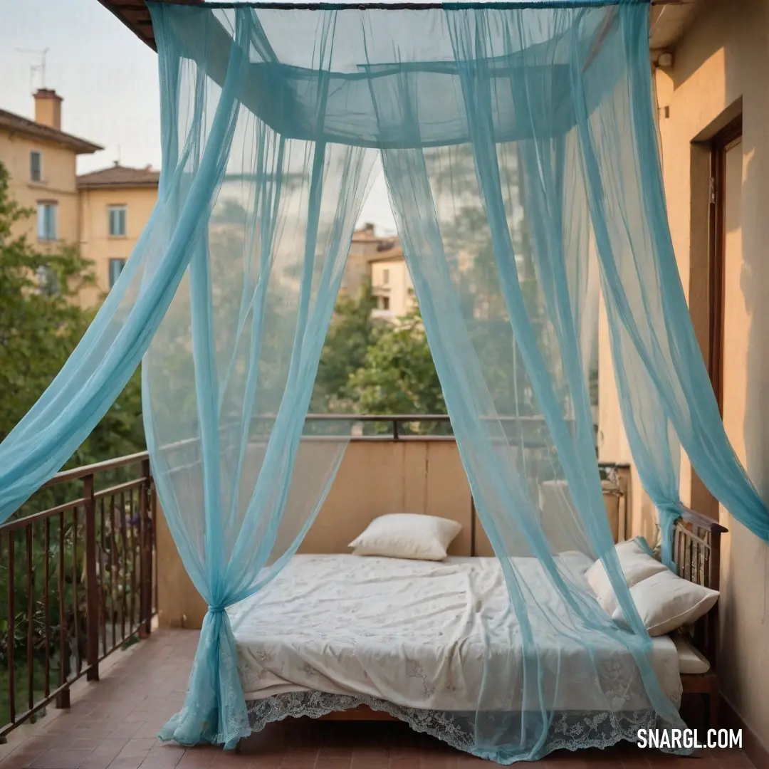 An enchanting bed with a whimsical canopy and soft white pillows rests gracefully on a balcony, gently draped with a flowing blue fabric, inviting relaxation amidst a picturesque view.