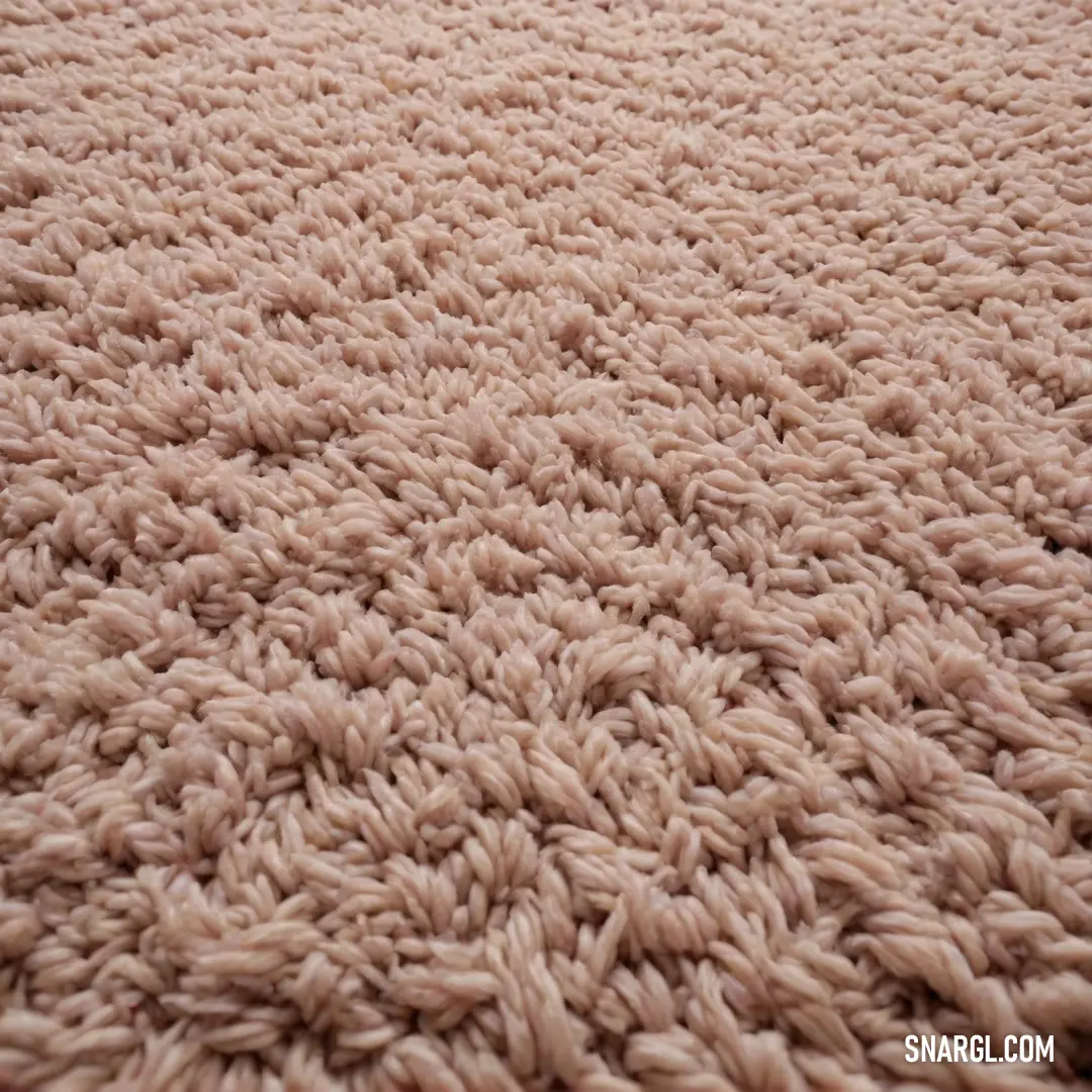 An intimate close-up of a beautifully patterned carpet, showcasing intricate browns and whites that flow seamlessly together. The colors accentuate a warm, inviting atmosphere reminiscent of a Bulgarian rose.