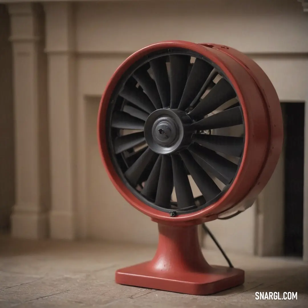 A cheerful red fan perched on a wooden table adds vibrancy to a cozy room, complemented by the flickering glow of a fireplace, creating an inviting atmosphere perfect for relaxation.