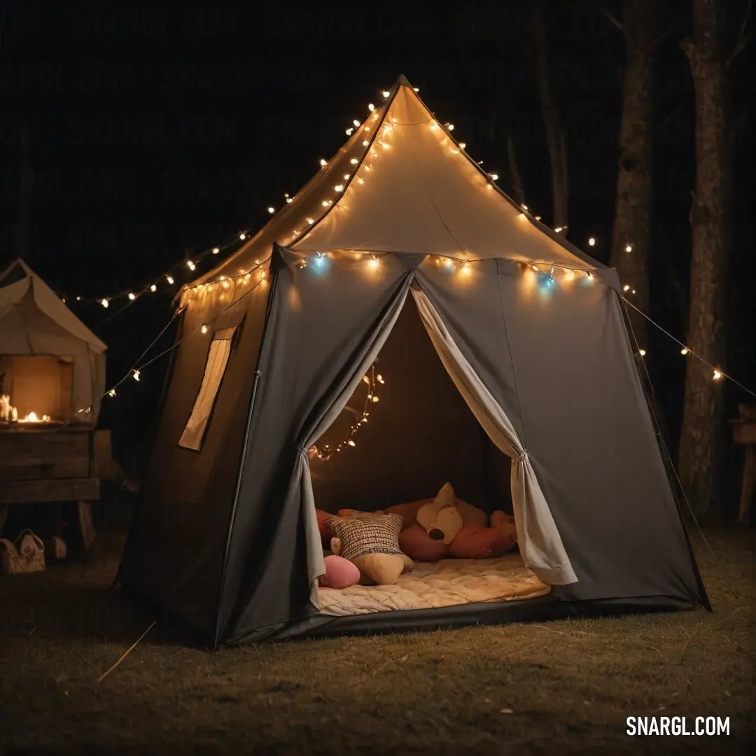 A charming tent adorned with soft lights sits beautifully in the grass, creating a cozy enclave, while a plush teddy bear rests inside, inviting dreams and adventures.