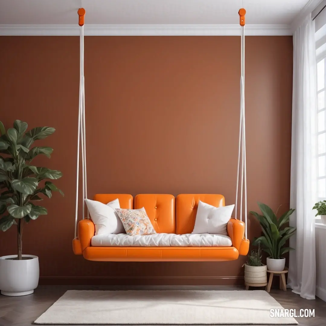 Living room with a couch and a potted plant in it and a window behind it with a curtain. Example of Burnt orange color.