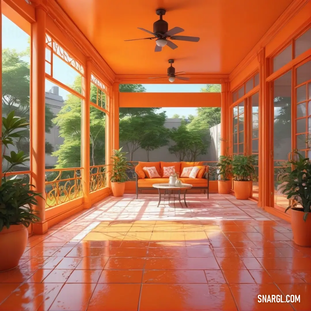 Room with a ceiling fan and a couch and table with a plant in it. Example of Burnt orange color.
