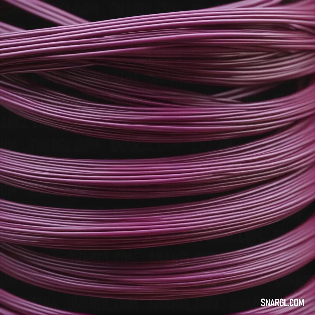 Close up of a purple wire on a black background. Color RGB 112,41,99.