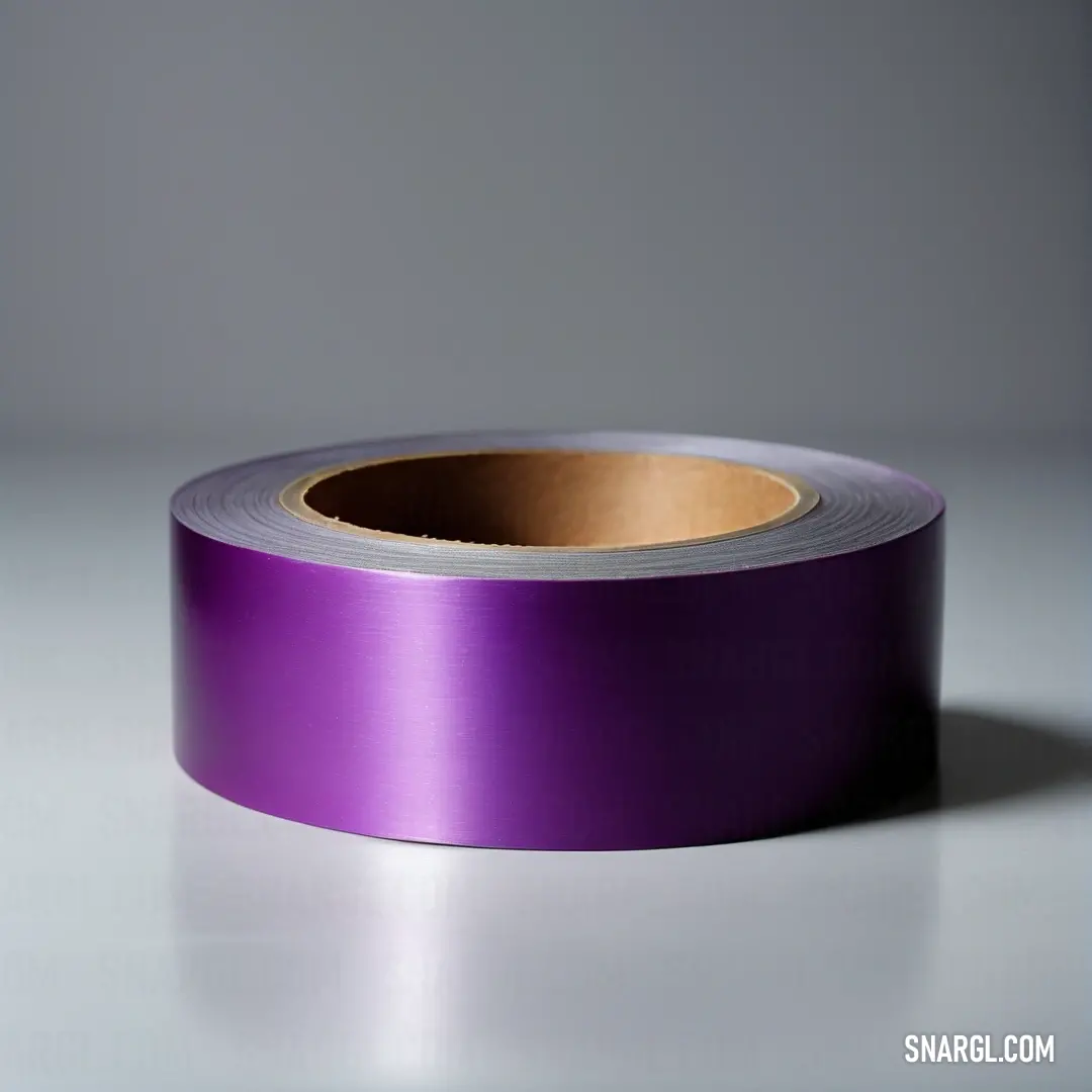 Byzantium color. Roll of purple satin tape on a white surface with a shadow on the floor