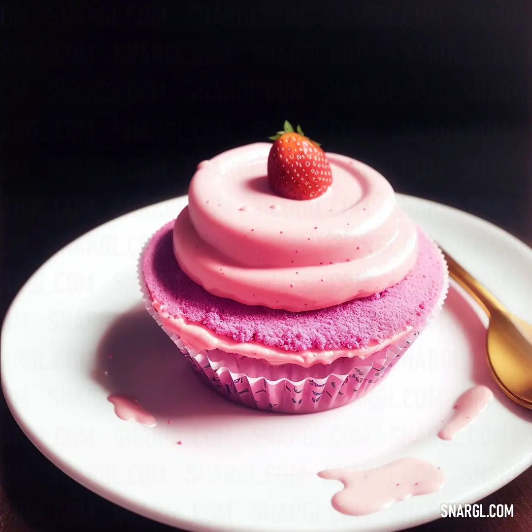 Cupcake with a strawberry on top on a plate with a spoon