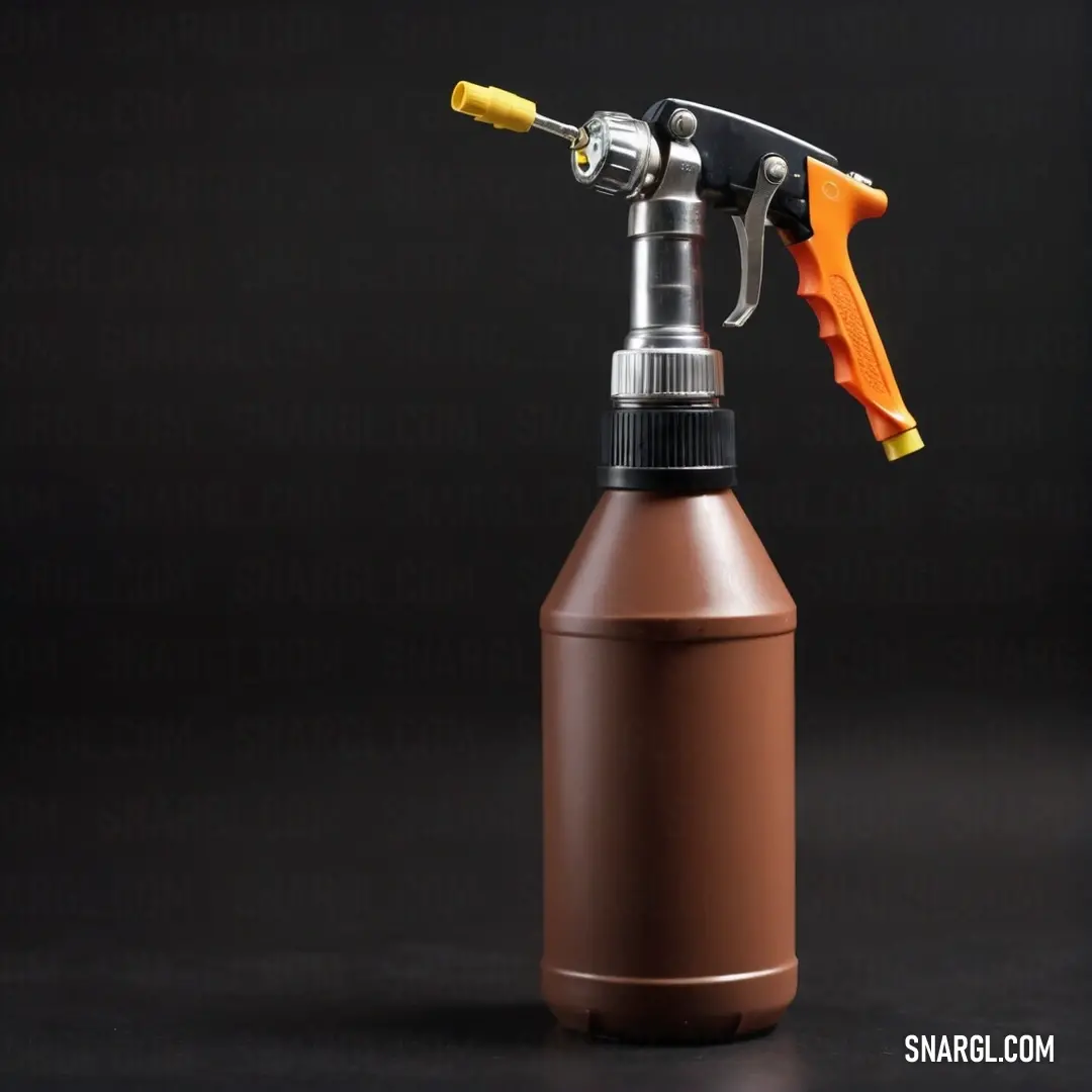 Brown spray bottle with a yellow handle and a yellow triggeror on top of it on a black surface. Color CMYK 0,56,64,65.