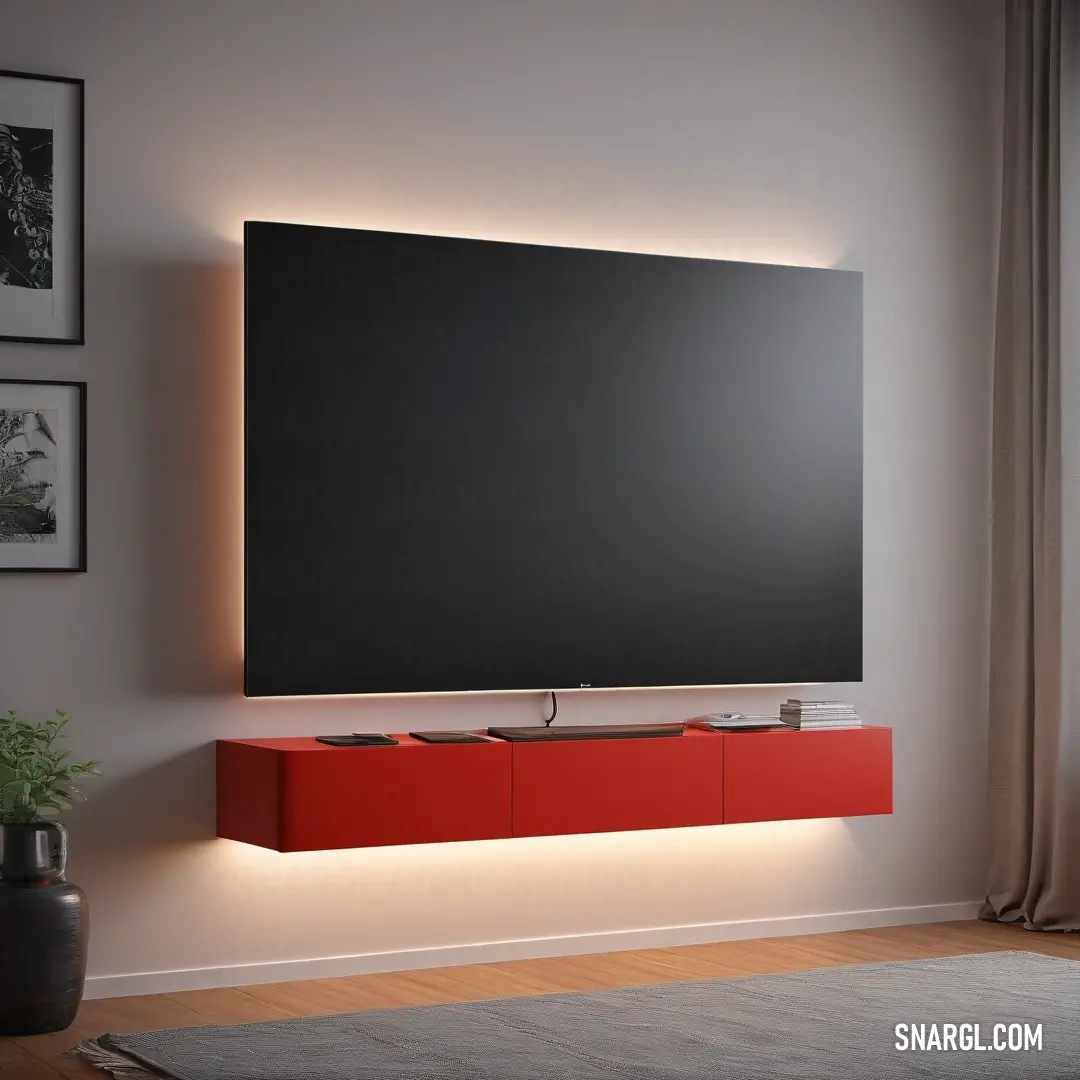Carnelian color example: Large television mounted on a wall above a red cabinet with a light on it's side and a plant in front of it