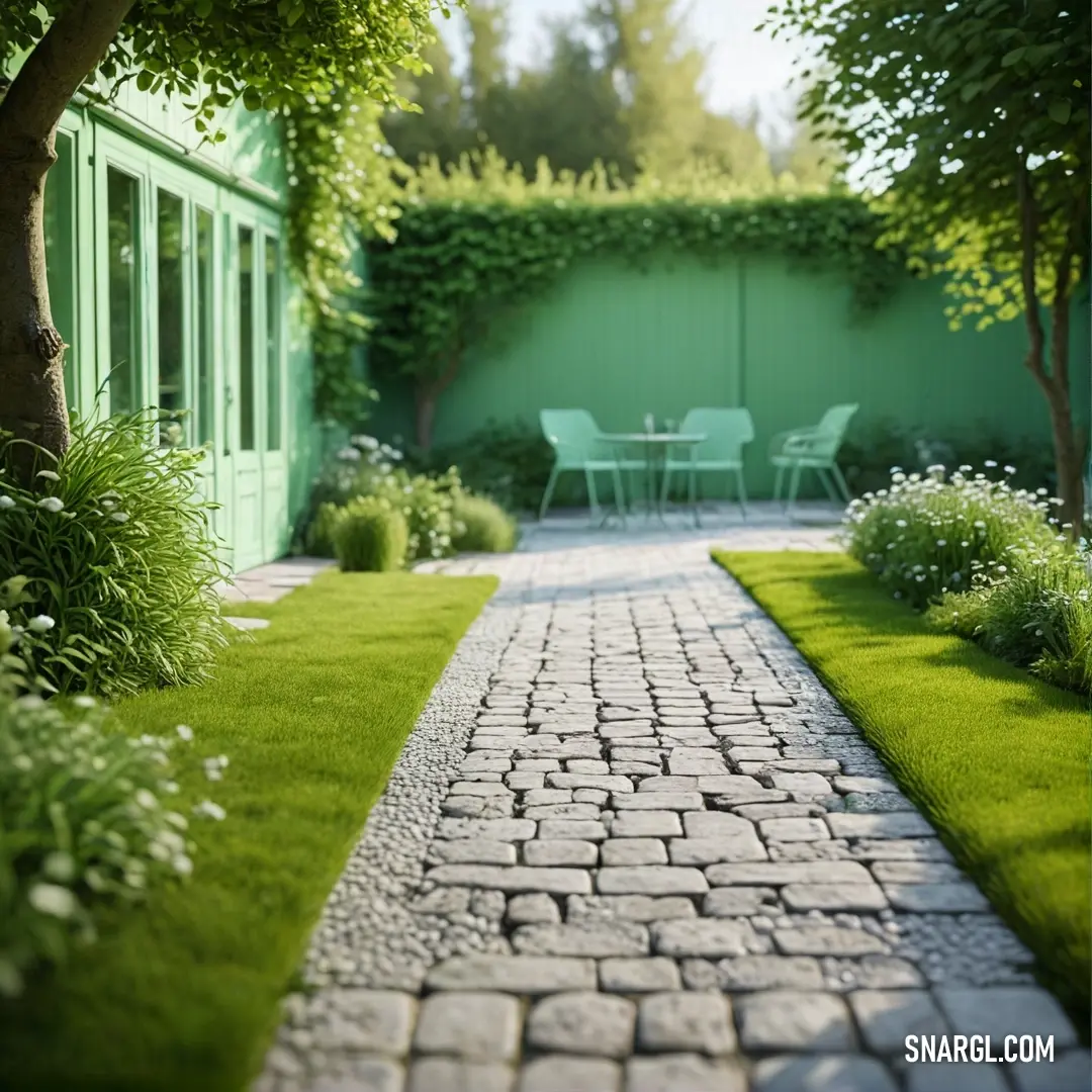 Brick path leads to a green garden with a table and chairs in the background. Color Celadon.