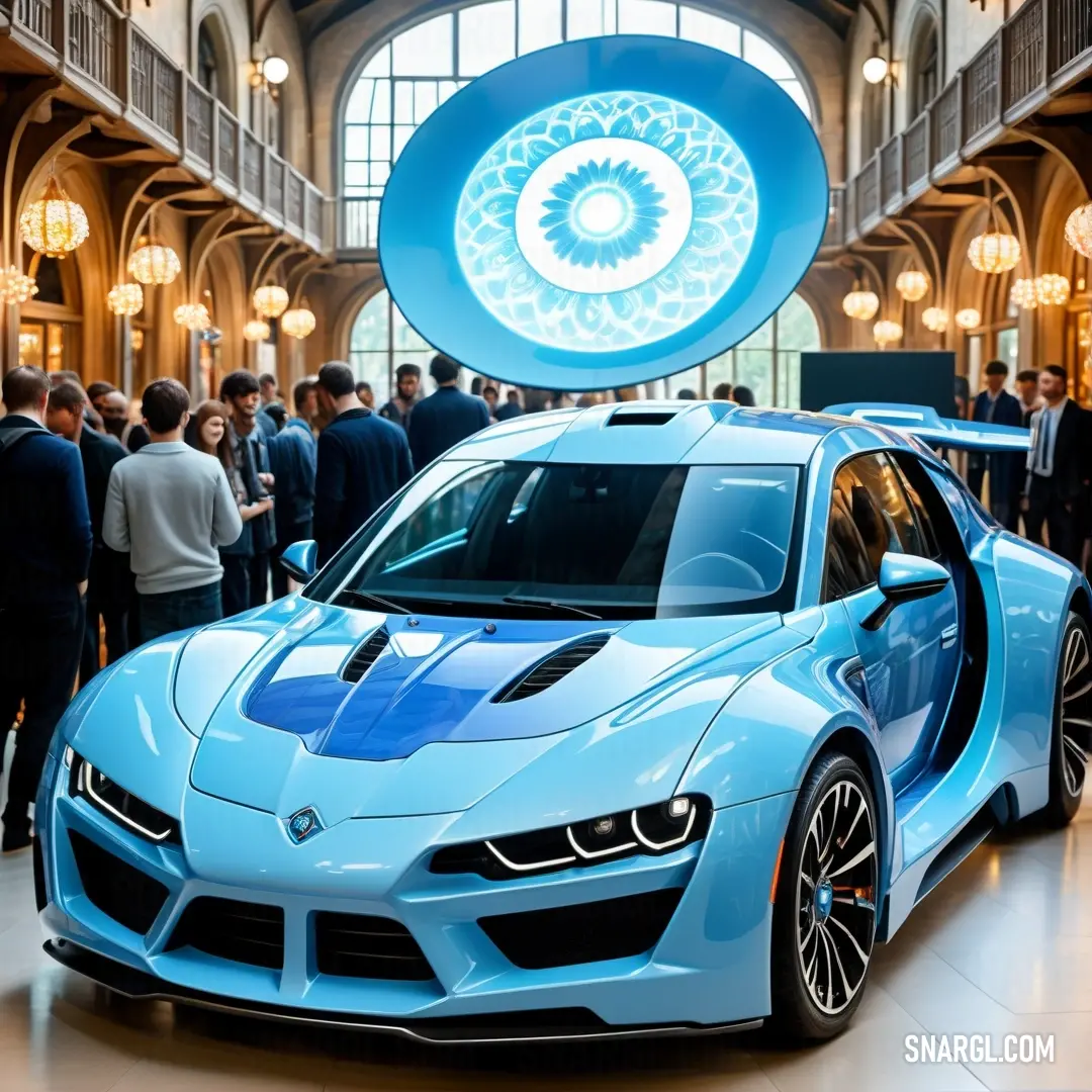 Blue sports car parked in a building with people standing around it and a circular window above it that has a circular light fixture