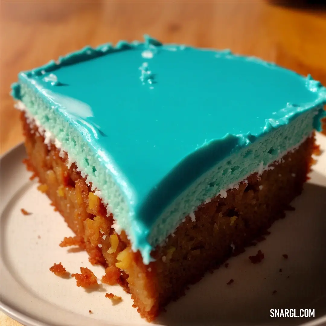 Piece of cake with blue frosting on a plate on a table with a wooden table top in the background