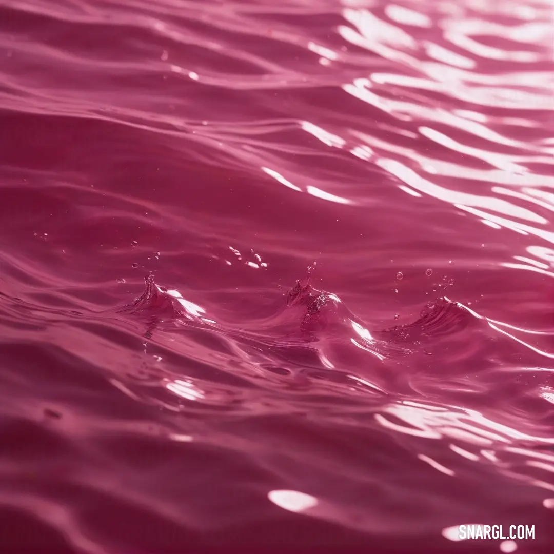 Cerise pink color example: Pink water surface with ripples and a small amount of water on the surface of the water