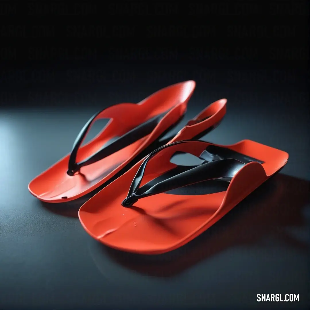 Pair of red and black flip flops on a table. Color #E03C31.