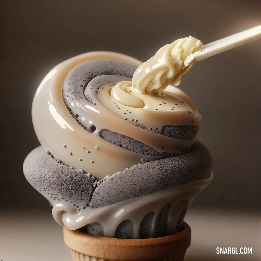 Cupcake with a spoon in it with a frosting swirl on top of it. Color #FAD6A5.