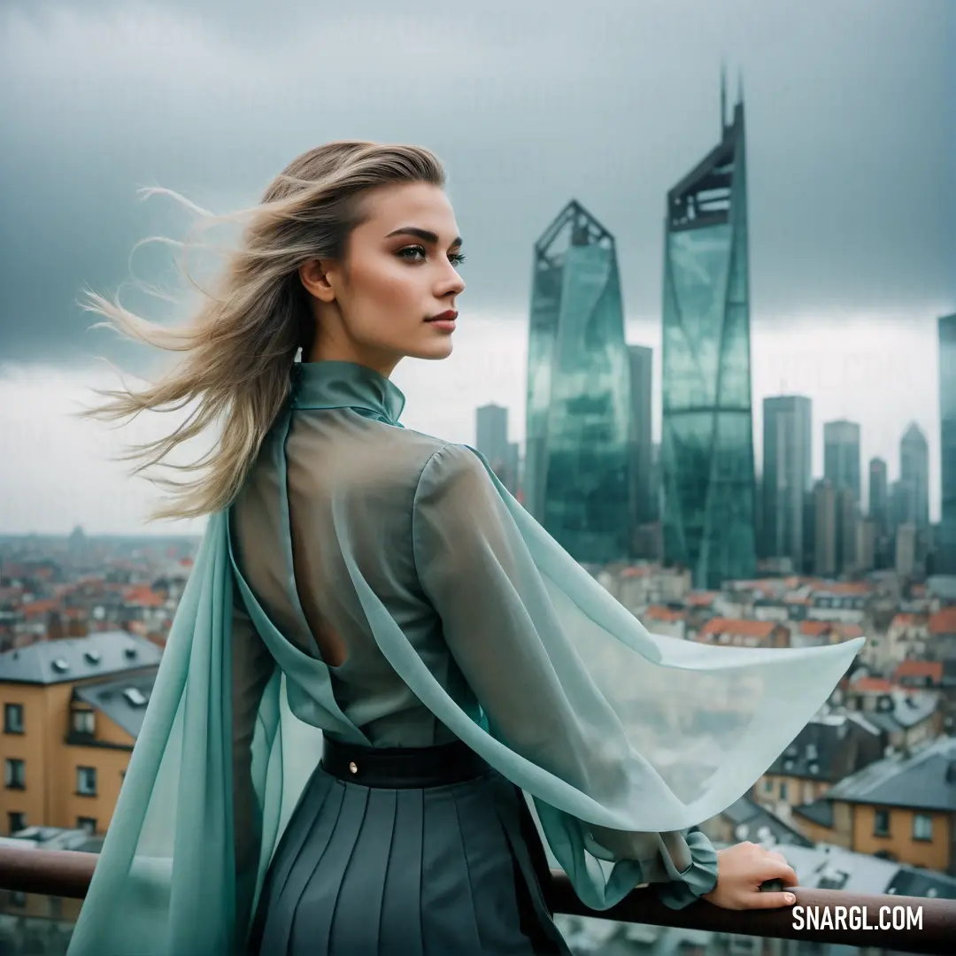 Woman with long hair standing on a balcony overlooking a cityscape with skyscrapers in the background