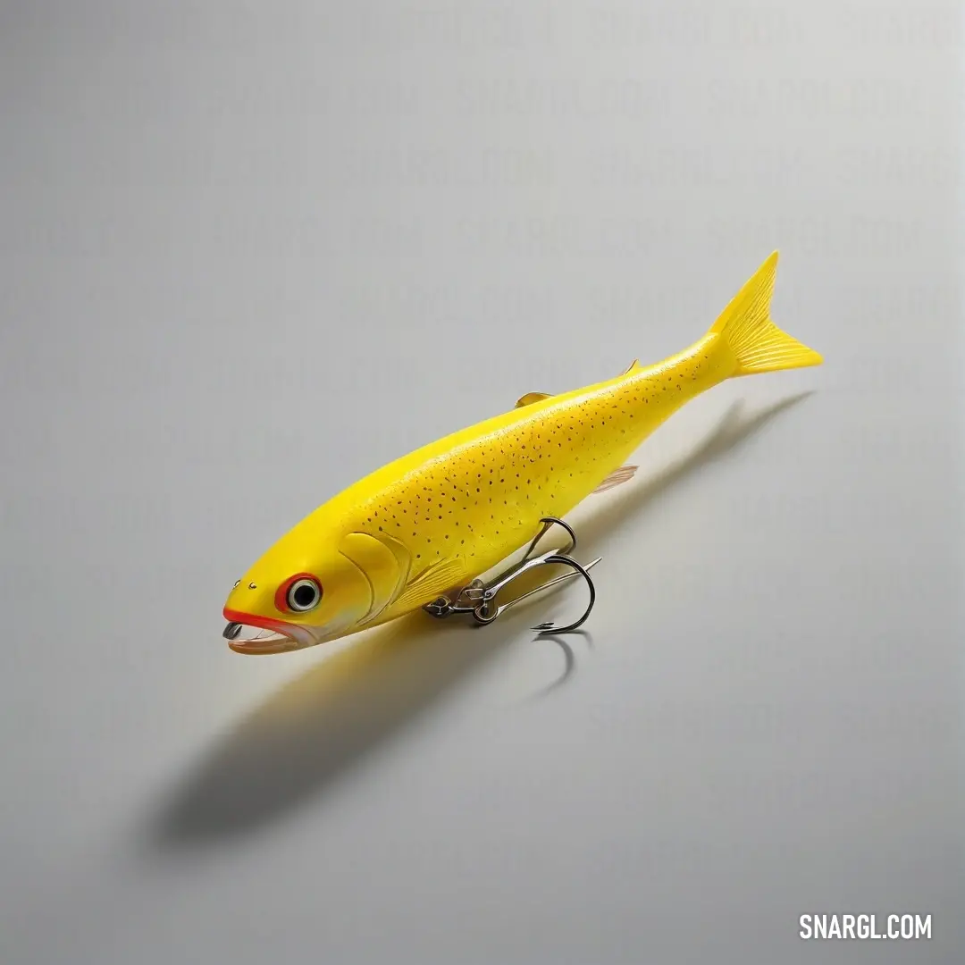 Yellow fish with a lure on it's side on a gray surface with a shadow of a fish. Example of Citrine color.
