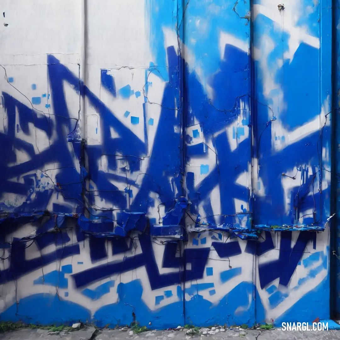 Blue and white wall with graffiti on it and a fire hydrant in front of it and a blue door