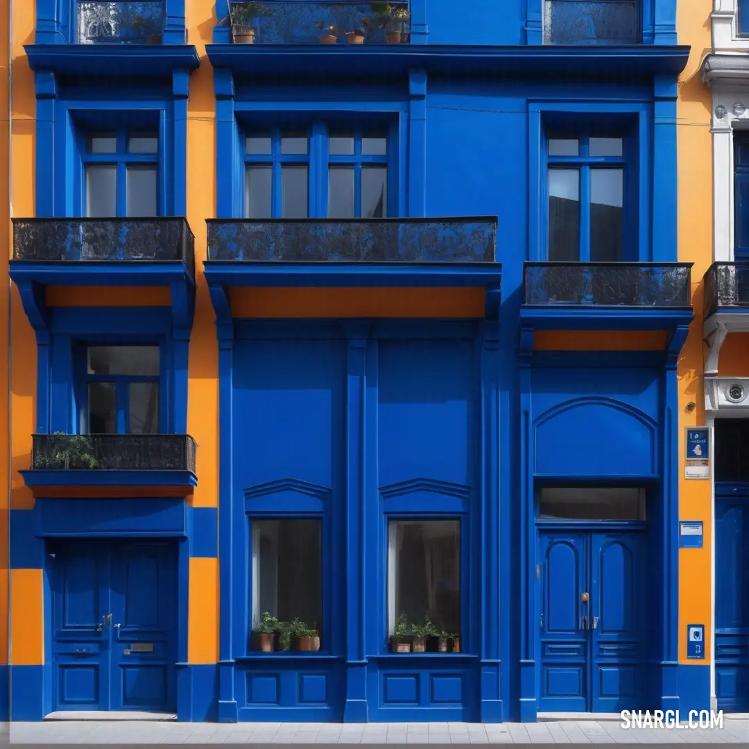 Cobalt color. Blue and yellow building with a clock on the front of it's face and windows on the side