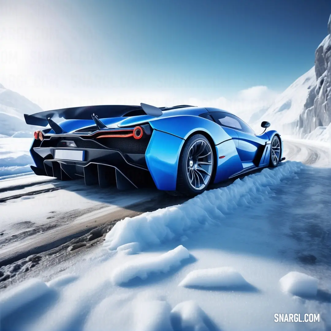 Cobalt color. Blue sports car driving on a snowy road in the mountains with a person standing on the front of it